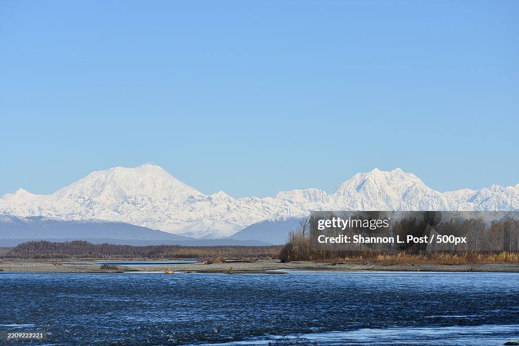 Snow-covered Sultana Mt Foraker and Begguya Mount Hunter rise above the Talkeetna River,Talkeetna,Alaska,United States,USA
