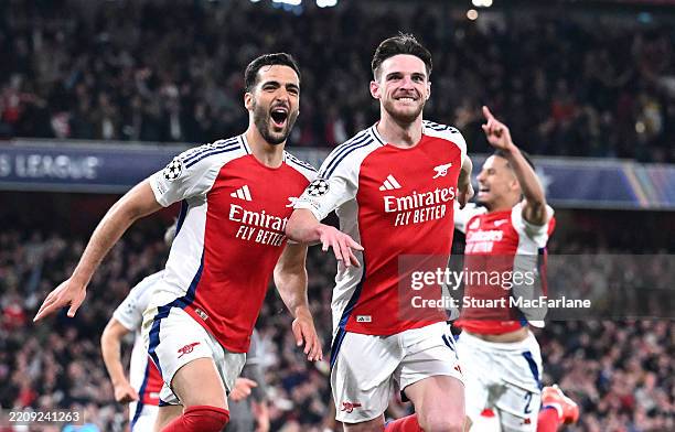 Mikel Merino of Arsenal celebrates scoring his team's third goal with teammate Declan Rice during the UEFA Champions League 2024/25 Quarter Final...
