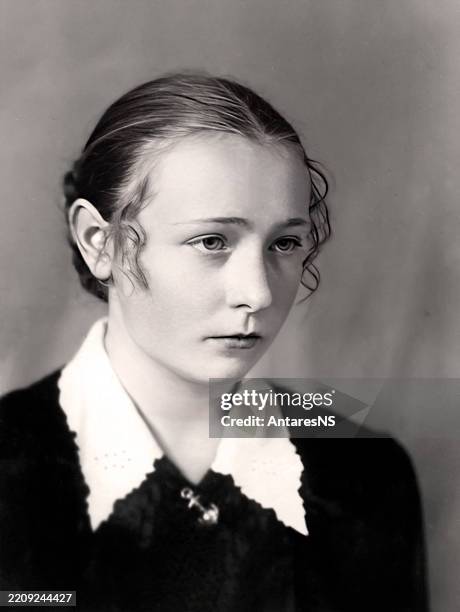 Vintage portrait of a beautiful sixteen year old girl half-turned. Retro photo from 1955.