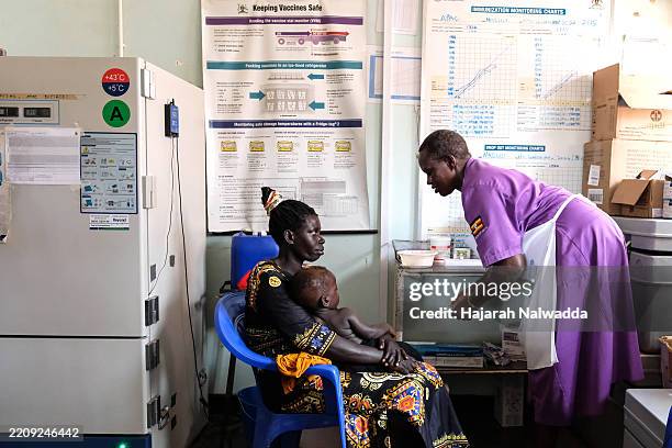 Hellen Akullo, a nurse assistant prepares a syringe by drawing a dose of malaria vaccine at Apac General Hospital on April 8, 2025 in Apac District,...
