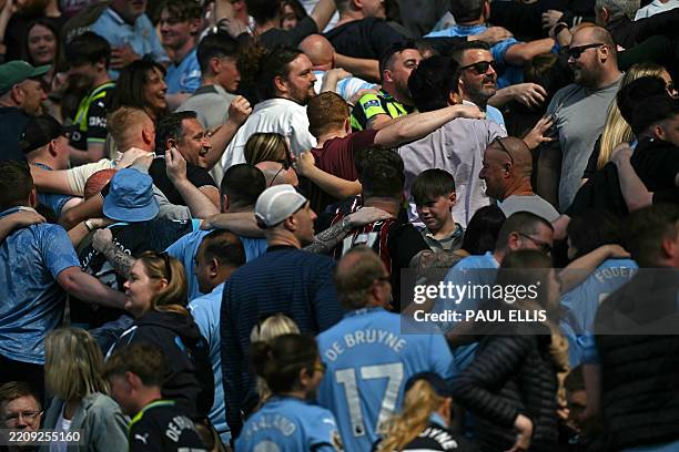 City fans do a half-hearted poznan celebration during the English Premier League football match between Manchester City and Crystal Palace at the...
