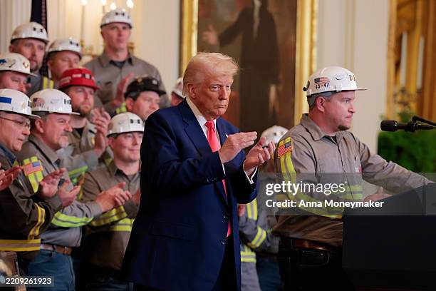 President Donald Trump listens as coal miner Jeff Crowe speaks during an executive order signing ceremony in the East Room of the White House on...