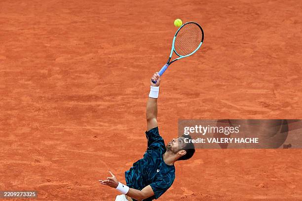 Italy's Lorenzo Musetti serves to Australia's Alex De Minaur during the Monte Carlo ATP Masters Series Tournament semi-final tennis match at the...