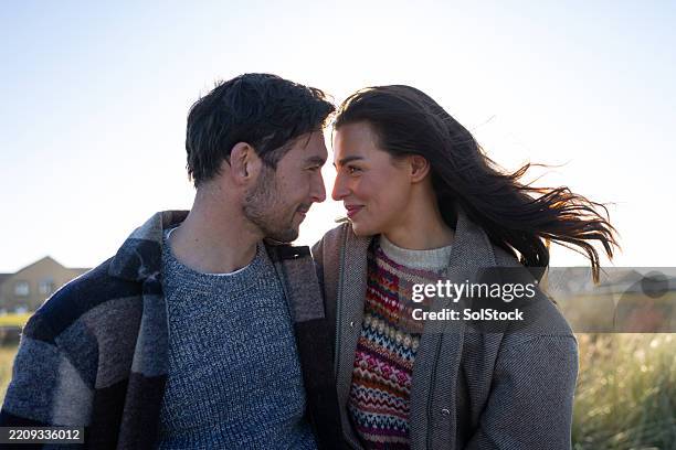 romantic couple embracing outdoors on a sunny day - face to face stock pictures, royalty-free photos & images