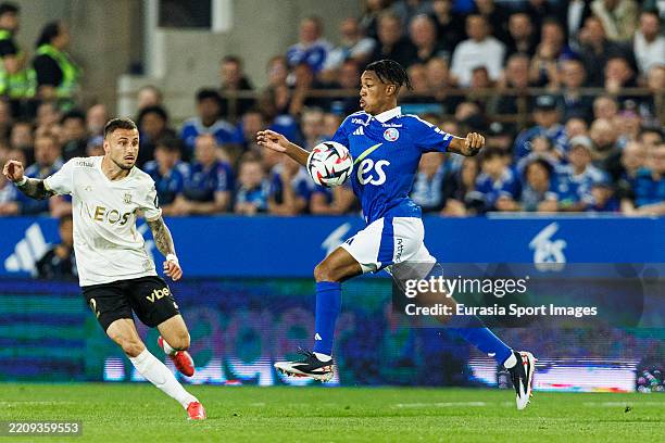Samuel Amo-Ameya of Strasbourg dribbles against Jonathan Clauss of Nice during the France Ligue 1 match between RC Strasbourg Alsace and OGC Nice at...