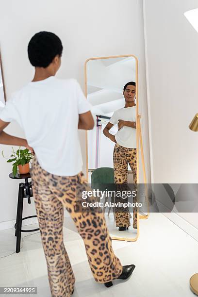 fashion designer looking at new pants design in the mirror - woman-looking-into-mirror-full-body stock pictures, royalty-free photos & images