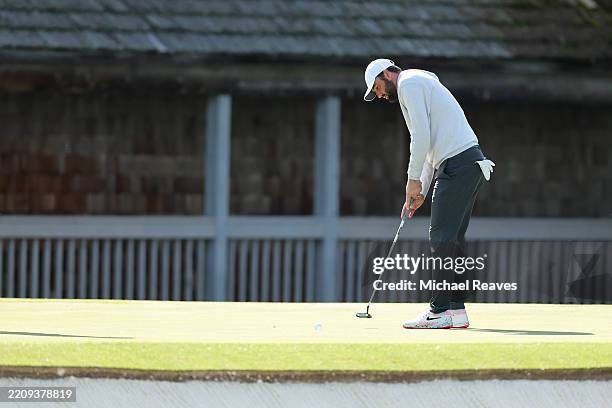 Scottie Scheffler of the United States putts on the 11th hole during a practice round prior to the 2025 Masters Tournament at Augusta National Golf...
