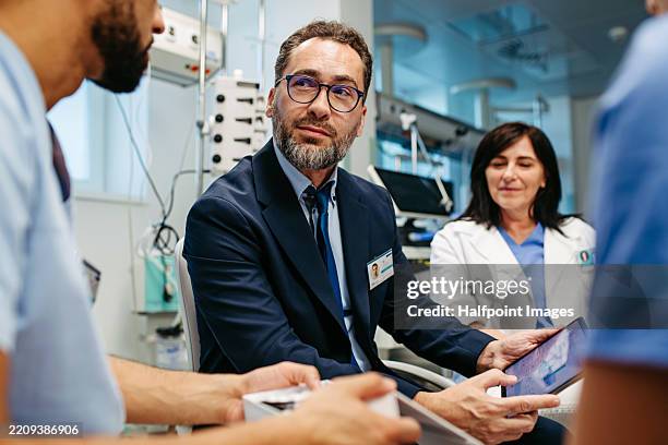 pharmaceutical sales respresentative during group presentation in hospital setting. - hospital director stock pictures, royalty-free photos & images