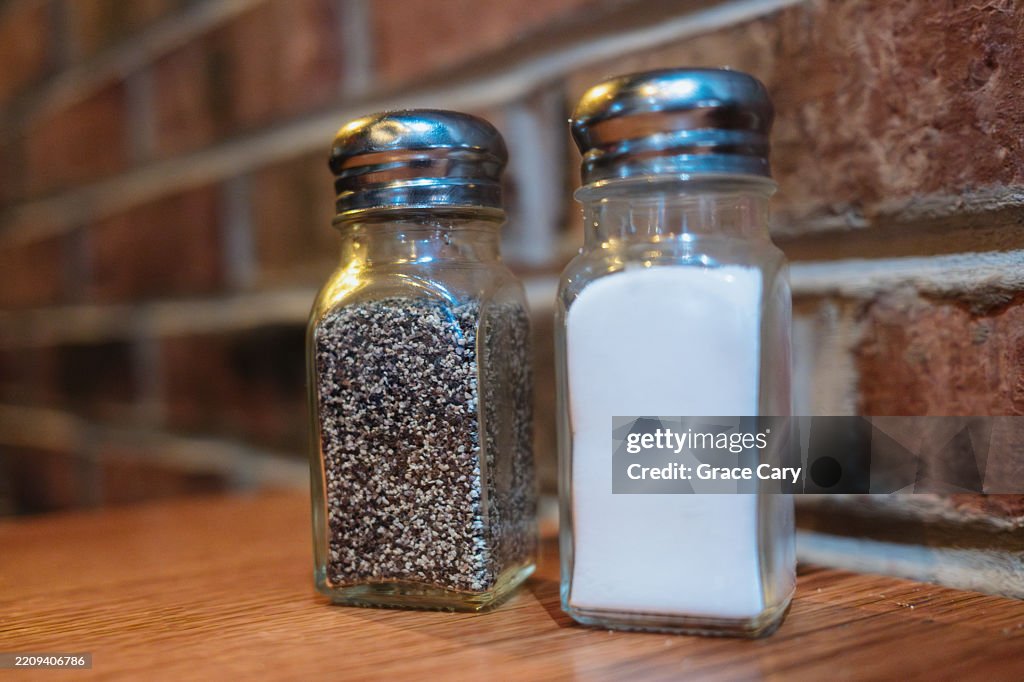 Salt and Pepper Shakers on Table in Restaurant