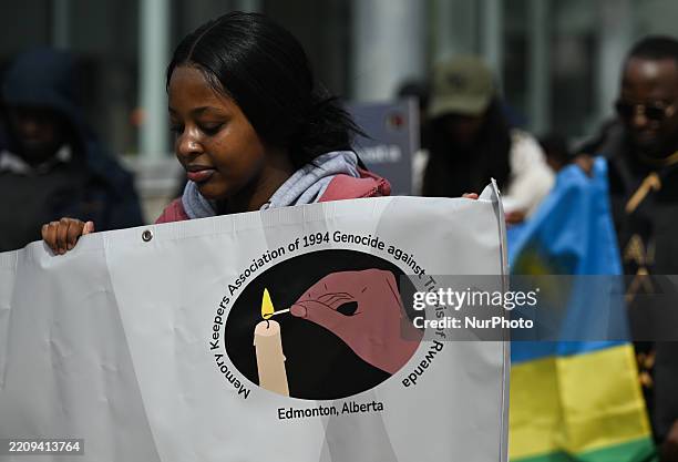 Members of the Memory Keepers Association, including survivors of the Rwandan genocide, their families, and supporters, participate in a...