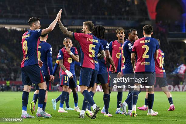 Robert Lewandowski of FC Barcelona high fives team mate Inigo Martinez after Raphinha of FC Barcelona scores his team's first goal during the UEFA...
