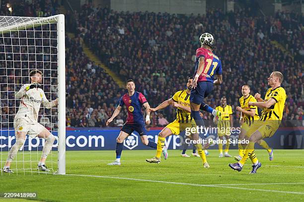 Raphinha of FC Barcelona heads the ball across goal before team mate Robert Lewandowski scores his team's second goal during the UEFA Champions...