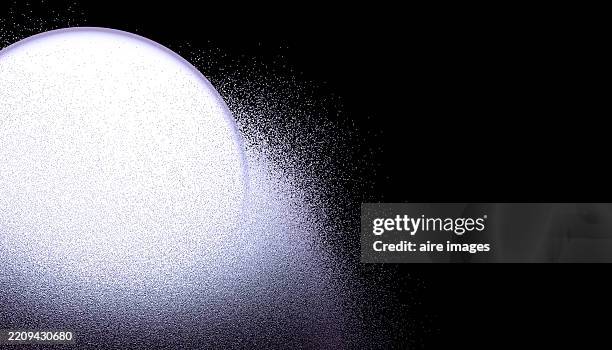 white sphere dissolving into particles on a black background - disolver fotografías e imágenes de stock