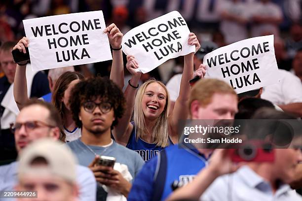 Fans hold signs in honor of Luka Doncic of the Los Angeles Lakers before the game against the Dallas Mavericks at American Airlines Center on April...