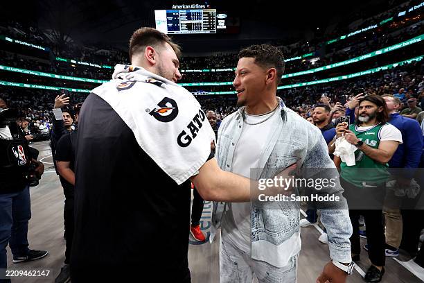 Luka Doncic of the Los Angeles Lakers embraces quarterback Patrick Mahomes after the game against the Dallas Mavericks at American Airlines Center on...