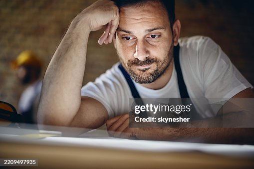Young manual worker having problems at construction site. Young manual worker having problems at construction site.