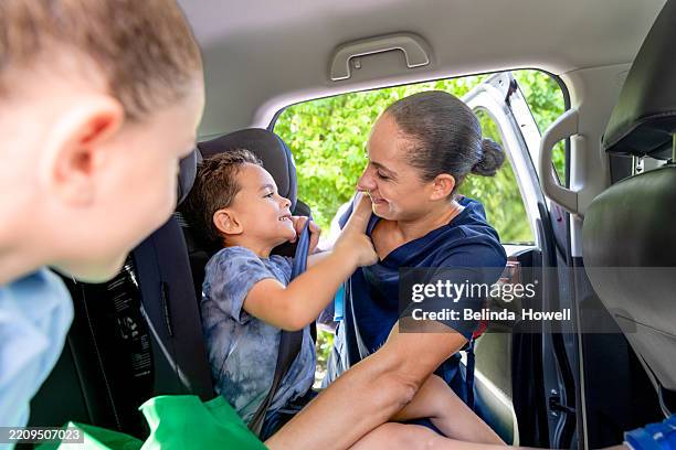 nurse spends time with her children after work - seat belt stock pictures, royalty-free photos & images