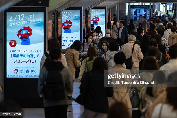 Passengers walk near monitors displaying an advertisement o the Expo 2025 Osaka, Kansai, Japan at a station on April 10, 2025 in Osaka, Japan. The...