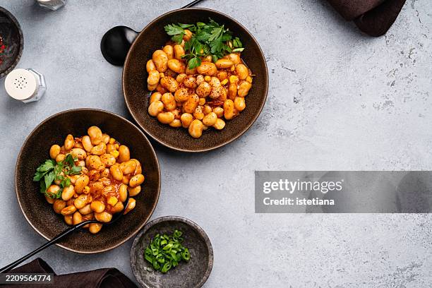 white bean stew with parsley on grey background - cannellini beans stock pictures, royalty-free photos & images
