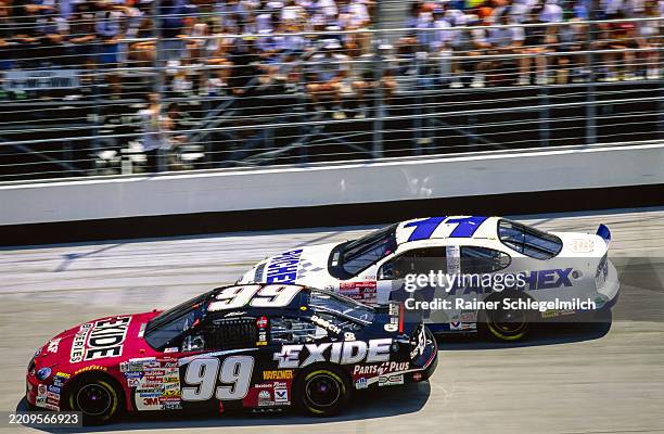 Jeff Burton's Roush Racing Ford side by side with Brett Bodine's BBR Ford during the NASCAR MBNA Platinum 400 at Dover Downs International Speedway,...