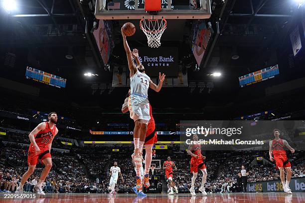 Jordan McLaughlin of the San Antonio Spurs drives to the basket during the game = on April 13, 2025 at the Frost Bank Center in San Antonio, Texas....