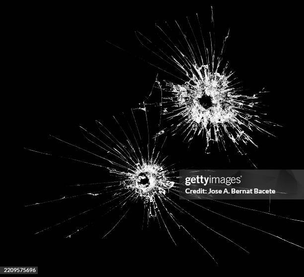 bullet holes in a black tinted car window. - broken gun stock pictures, royalty-free photos & images