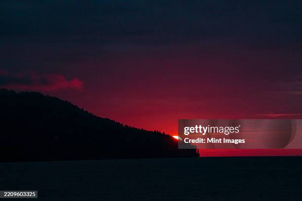 sun setting over striped peak, port angeles in washington state - port angeles washington state stock pictures, royalty-free photos & images