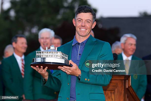 Rory McIlroy of Northern Ireland holds the trophy after receiving the Green Jacket following his victory in a playoff during the final round of the...