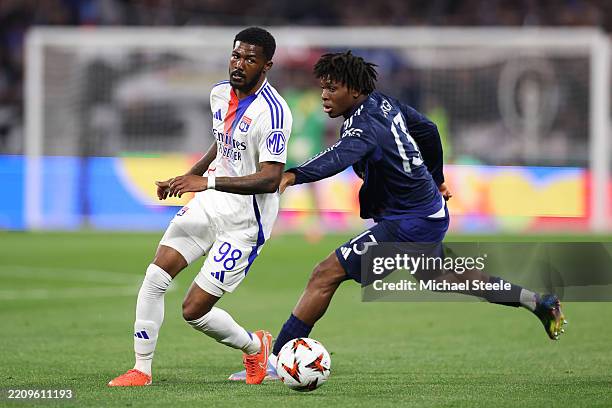Ainsley Maitland-Niles of Olympique Lyonnais passes the ball whilst under pressure from Patrick Chinazaekpere Dorgu of Manchester United during the...