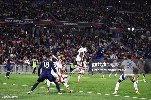 Leny Yoro of Manchester United scores his team's first goal whilst under pressure from Paul Akouokou of Olympique Lyonnais during the UEFA Europa...