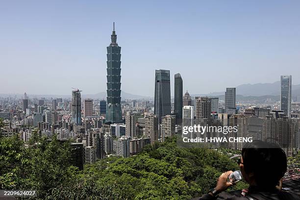 The city skyline is seen with the landmark Taipei 101 building from a lookout point on Elephant Mountain in Taipei on April 14, 2025.