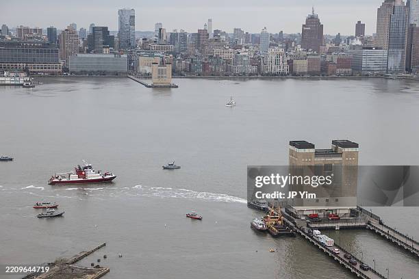 Rescue boats surround the crash site of a helicopter in the Hudson River on April 10, 2025 in Jersey City, New Jersey. Six people, including a family...