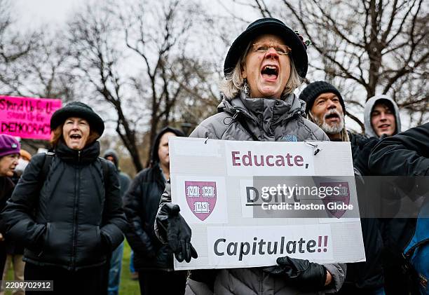 Cambridge, MA A protester holds a sign reading "Educate, Don't Capitulate!!" featuring Harvard University shields during a rally at Cambridge Common....