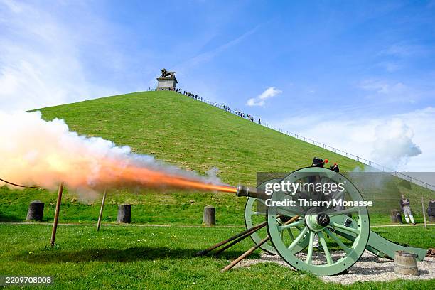 Extras demonstrate firing a French 4-pounder cannon under the Lion's Mound on April 14, 2025 in Braine-l'Alleud, Belgium. The Battle of Waterloo took...