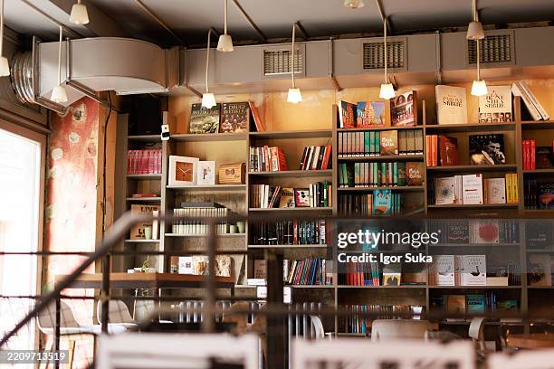 bookshelves full of colorful books inviting customers to reading - book shop stock pictures, royalty-free photos & images
