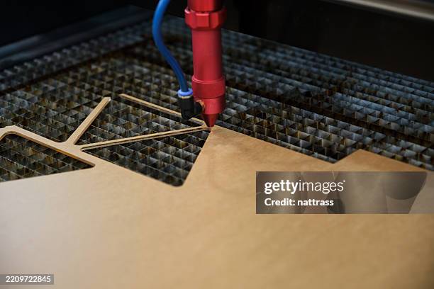 laser cutter carving intricate patterns into a material sheet - laser engraving stock pictures, royalty-free photos & images