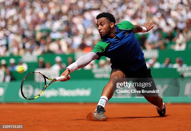 Arthur Fils of France stretches for a backhand against Carlos Alcaraz of Spain in the Men's Singles Quarterfinal match during day six of the Rolex...