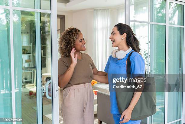 same-sex couple smiling and greeting each other at home - nurse flirting stock pictures, royalty-free photos & images