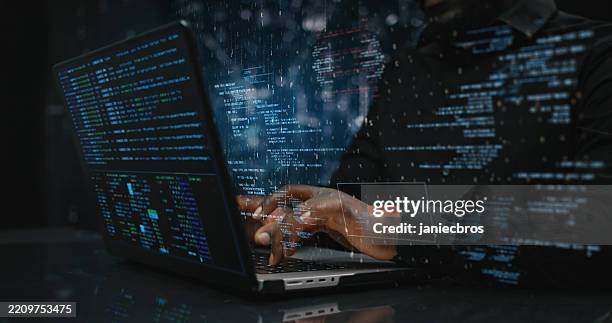 hands of male sitting in front of computer, writing on keyboard focused on hacking as blue team or red team specialist searching for any vulnerability in system - hacker imagens e fotografias de stock
