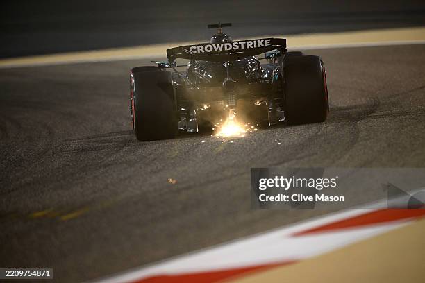 Sparks fly behind George Russell of Great Britain driving the Mercedes AMG Petronas F1 Team W16 on track during practice ahead of the F1 Grand Prix...