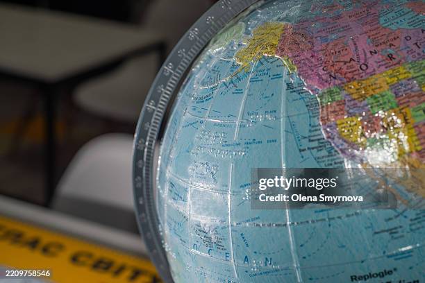 inclusive globe written in braille and with raised map outlines - breitengrad stock-fotos und bilder