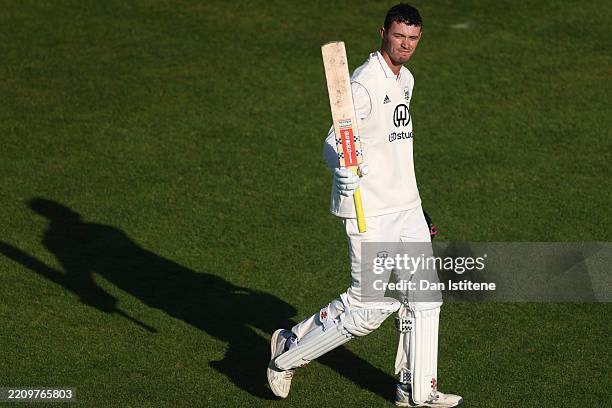 Oliver Price of Gloucestershire acknowledges the crowd as he leaves the field after losing his wicket one ball after reaching his century during day...