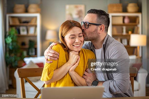 the husband congratulates his wife on her success - auctioneer stock pictures, royalty-free photos & images