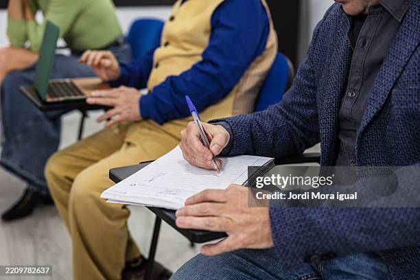 students taking notes during adult learning class - spelling test stock pictures, royalty-free photos & images