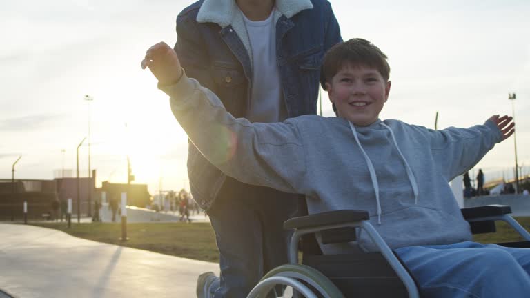 https://media.gettyimages.com/id/2209804173/video/a-father-takes-his-son-with-special-needs-on-a-ride-in-a-wheelchair-to-a-city-park-where-they.jpg?b=1&s=640x640&k=20&c=ZE6fTHCUdwH8lzg1UssAM4CUhn6Gyj9wUhSjM6aMw6E=