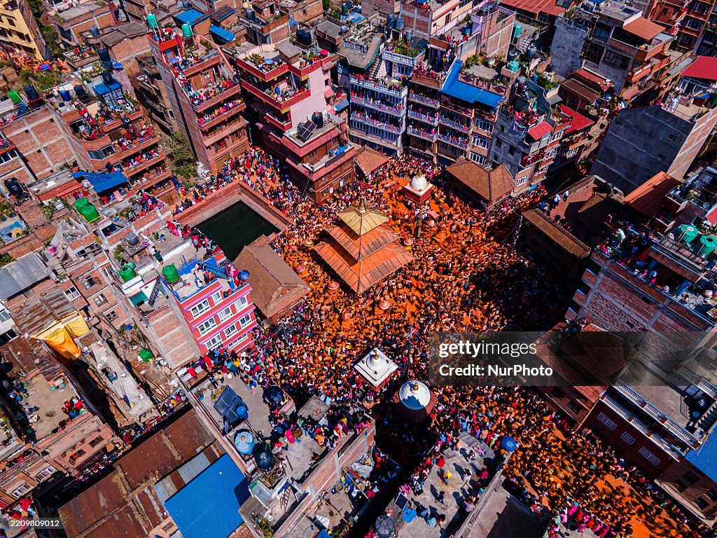 Bisket The aerial view shows Nepalese devotees playing with vermilion powder ...