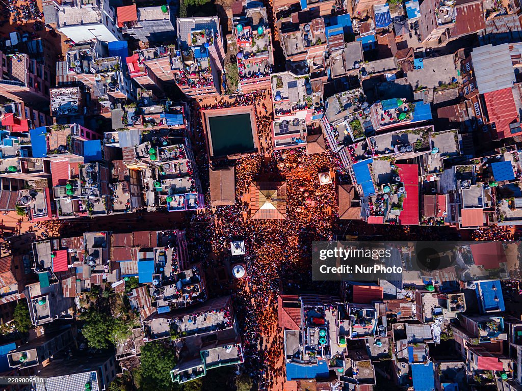 Bisket The aerial view shows Nepalese devotees playing with vermilion powder ...