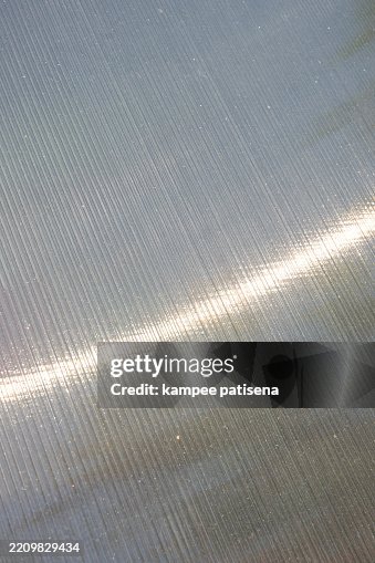 A shiny silver polycarbonate surface with a pattern A shiny silver polycarbonate surface with a pattern
