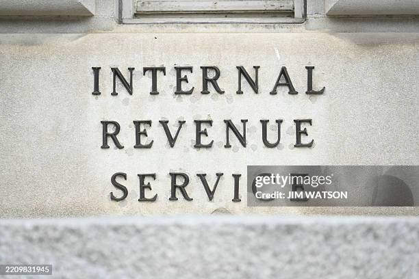 Signage for the Internal Revenue Service is seen outside IRS headquarters in Washington, DC, on April 15, 2025. The US federal tax agency has reached...
