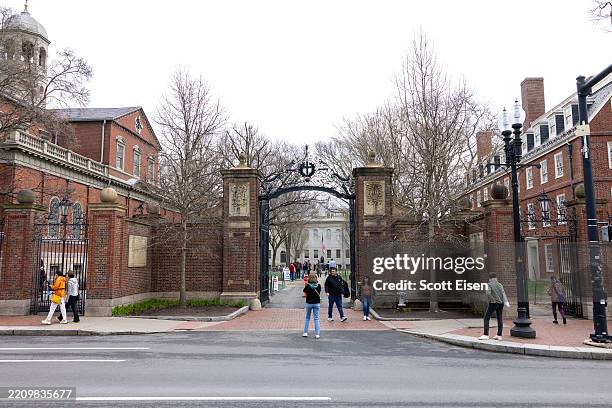 Tourists in front of the main gate to Harvard Yard on April 15, 2025 in Cambridge, Massachusetts. A Trump administration task force announced Monday...